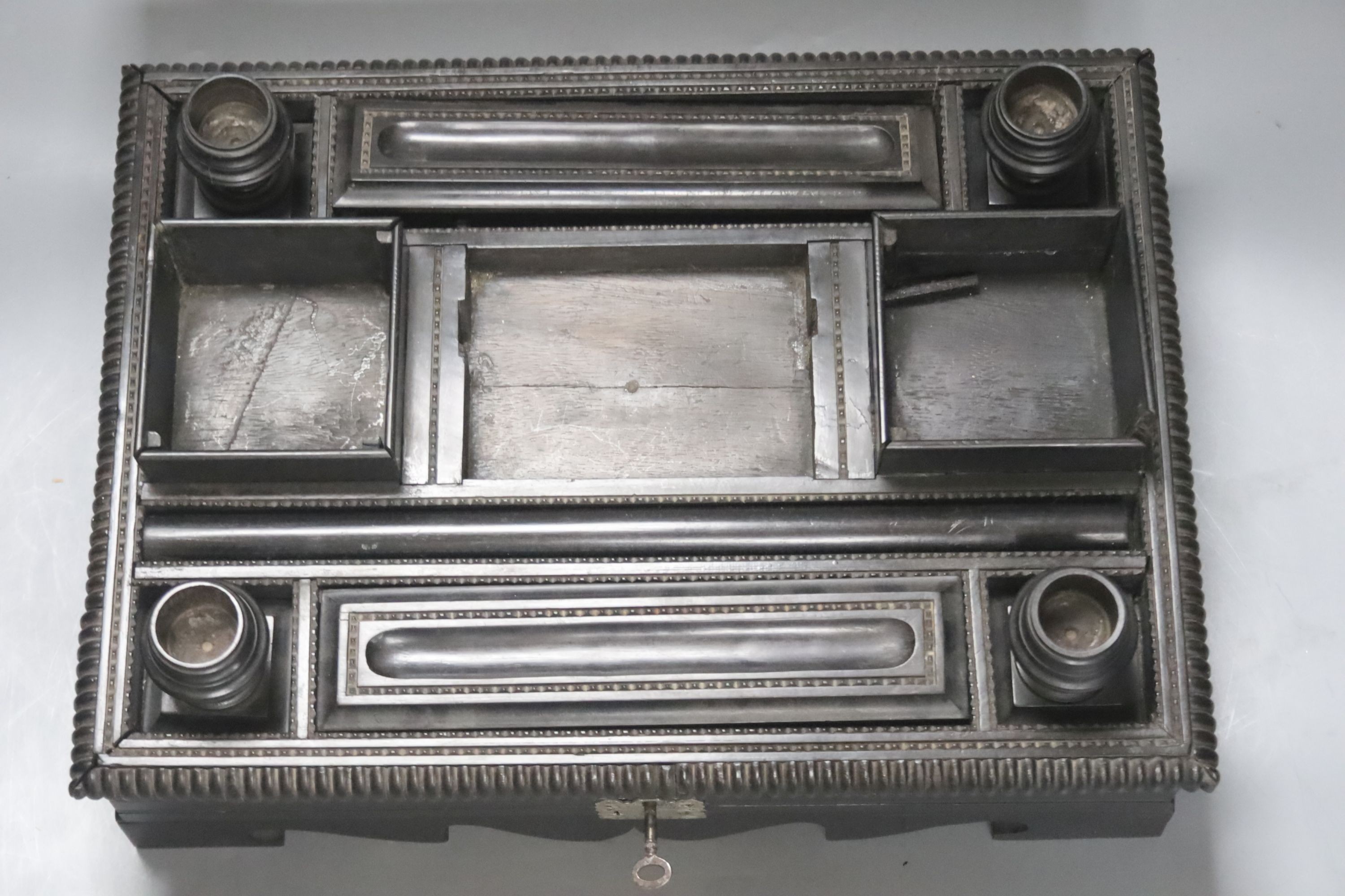 A 19th century Indo-Colonnial ebony desk stand, single drawer with engraved white metal escutcheon, width 37cm